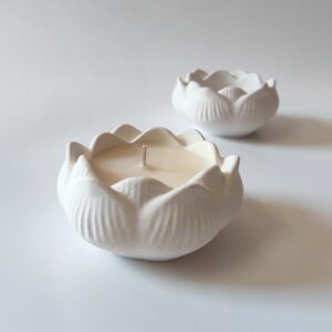 Concrete lotus candle with layered petals and light cream finish