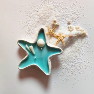 Concrete starfish candle with blue-green center and scented decorative design